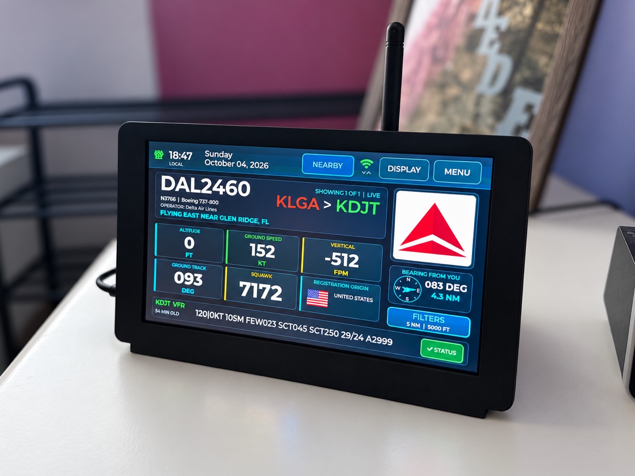 My Flight Tracker 7-inch HD display showing aircraft details in its black desktop enclosure